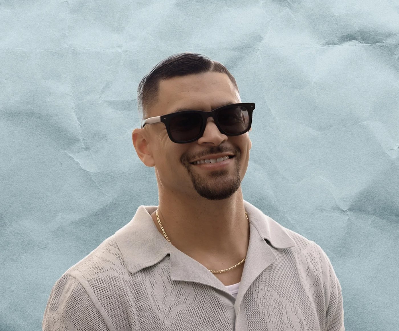 Brandon Cruz, DJ FLiPZ, wearing sunglasses and a knit shirt